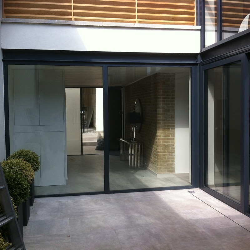 Floor-to-ceiling sliding doors opening to courtyard in Golders Green