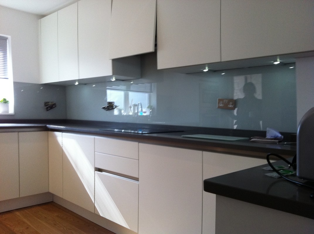 Grey glass kitchen splashback with LED lighting in Golders Green